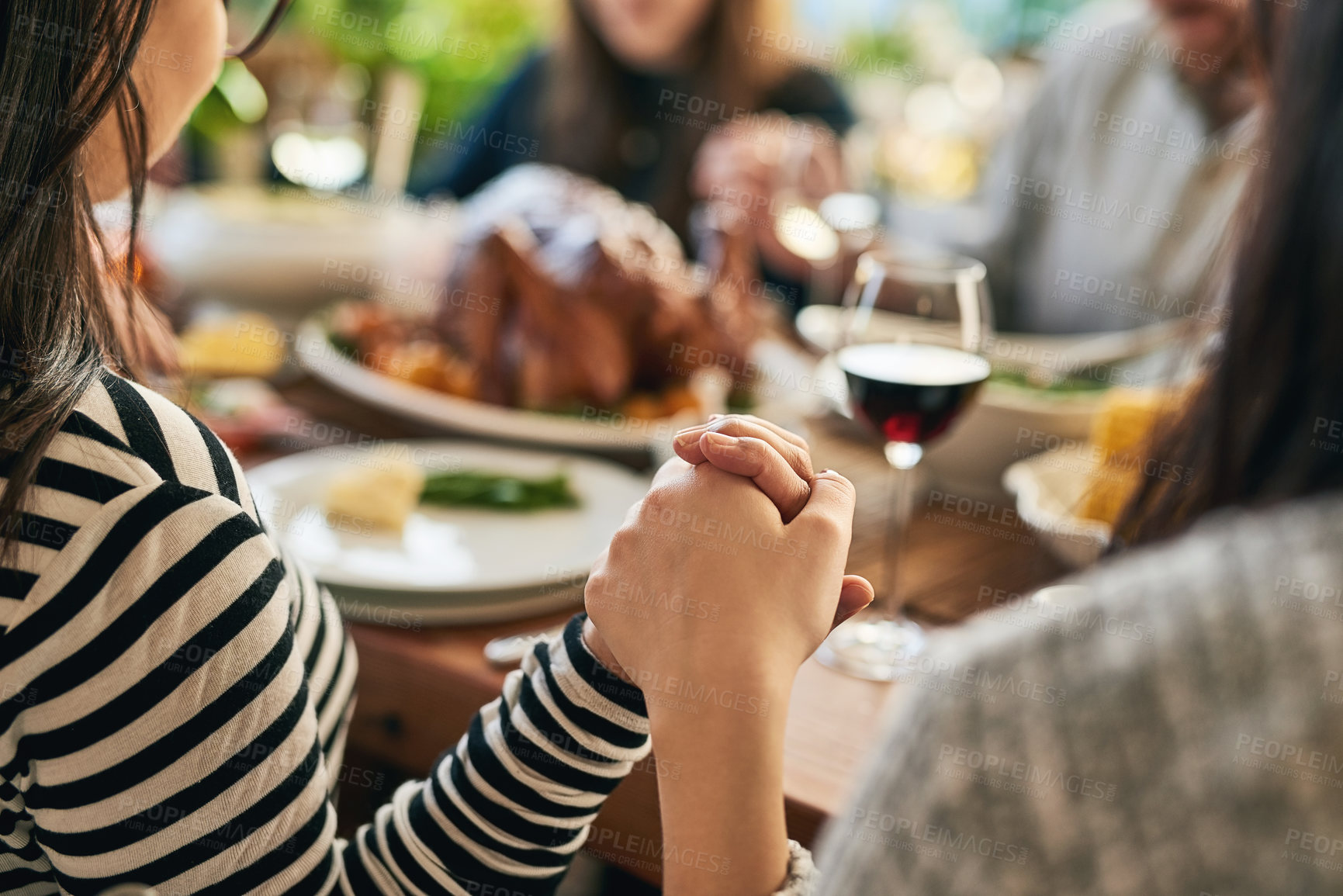 Buy stock photo Food, praying and family holding hands for prayer with parents and children gathering at a dinner table at home. God, worship and grateful people with gratitude enjoy a thanksgiving meal with turkey
