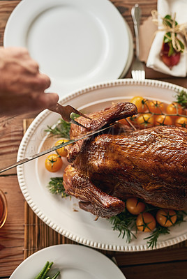 Buy stock photo Thanksgiving, food and hands with a turkey carving on a dinner table from above for a celebration event. Tradition, chicken and Christmas with a man cutting meat with a fork before enjoying a meal
