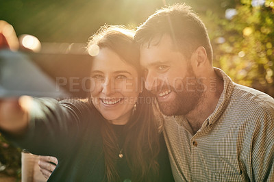 Buy stock photo Phone, love and couple take a selfie for social media on a honeymoon date at a restaurant outdoors in summer. Smile, romance and happy woman enjoys taking photos with a romantic partner on holiday