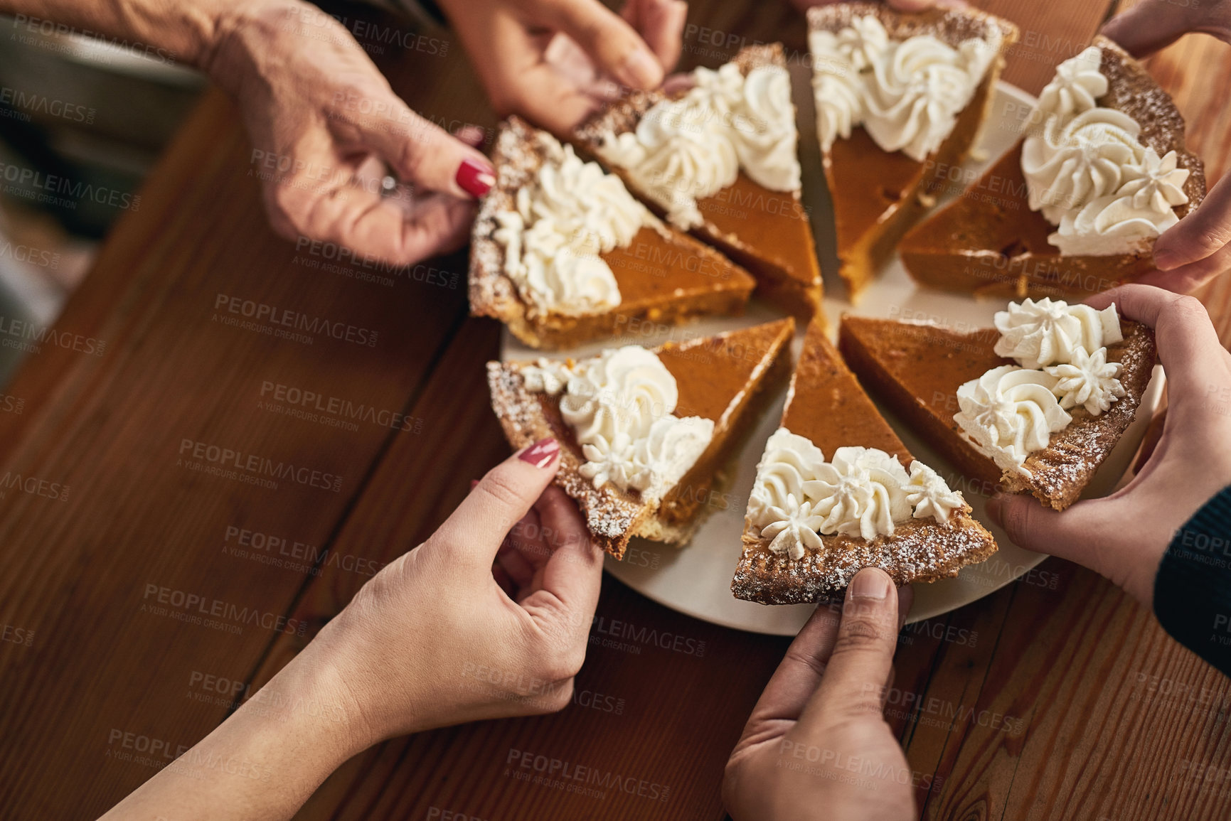 Buy stock photo Family, hands and pumpkin pie by people in celebration of thanksgiving, fun and social gathering at a table closeup. Hand, cake and friends share traditional dessert at an event, party or function 