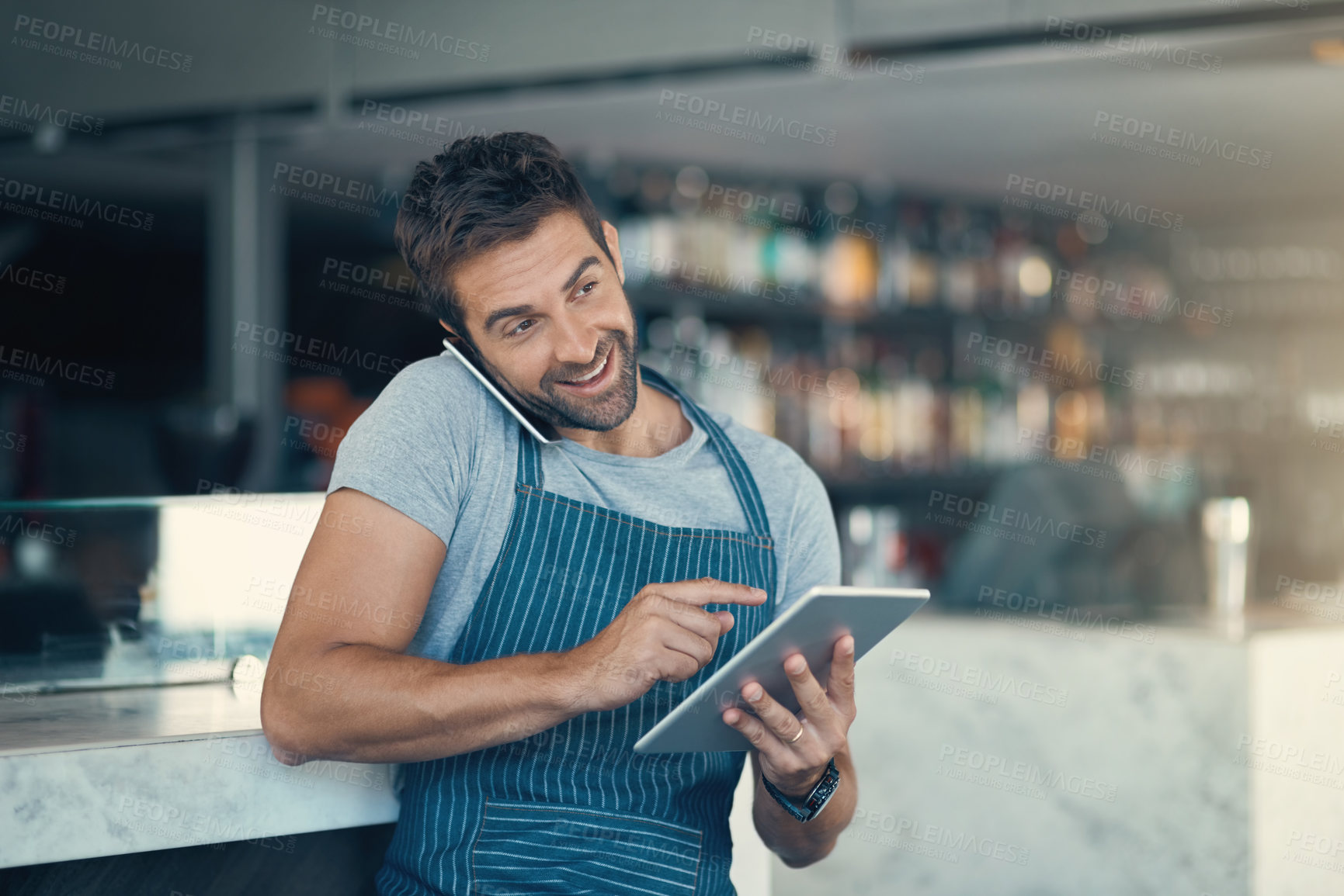 Buy stock photo Happy man, waiter and phone call with tablet for reservation, online booking or order at cafe. Male person or barista talking with smile, technology or mobile smartphone for service at restaurant