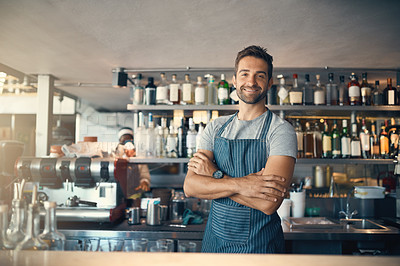 Buy stock photo Portrait of a young man working behind a bar counter