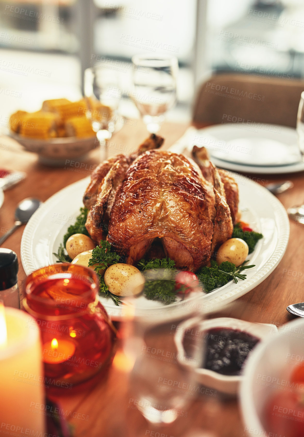 Buy stock photo Thanksgiving, food and celebration with a turkey serving on a table in a home for tradition in the holidays. Christmas, chicken and eating with a meal served on a wooden surface from above for dining