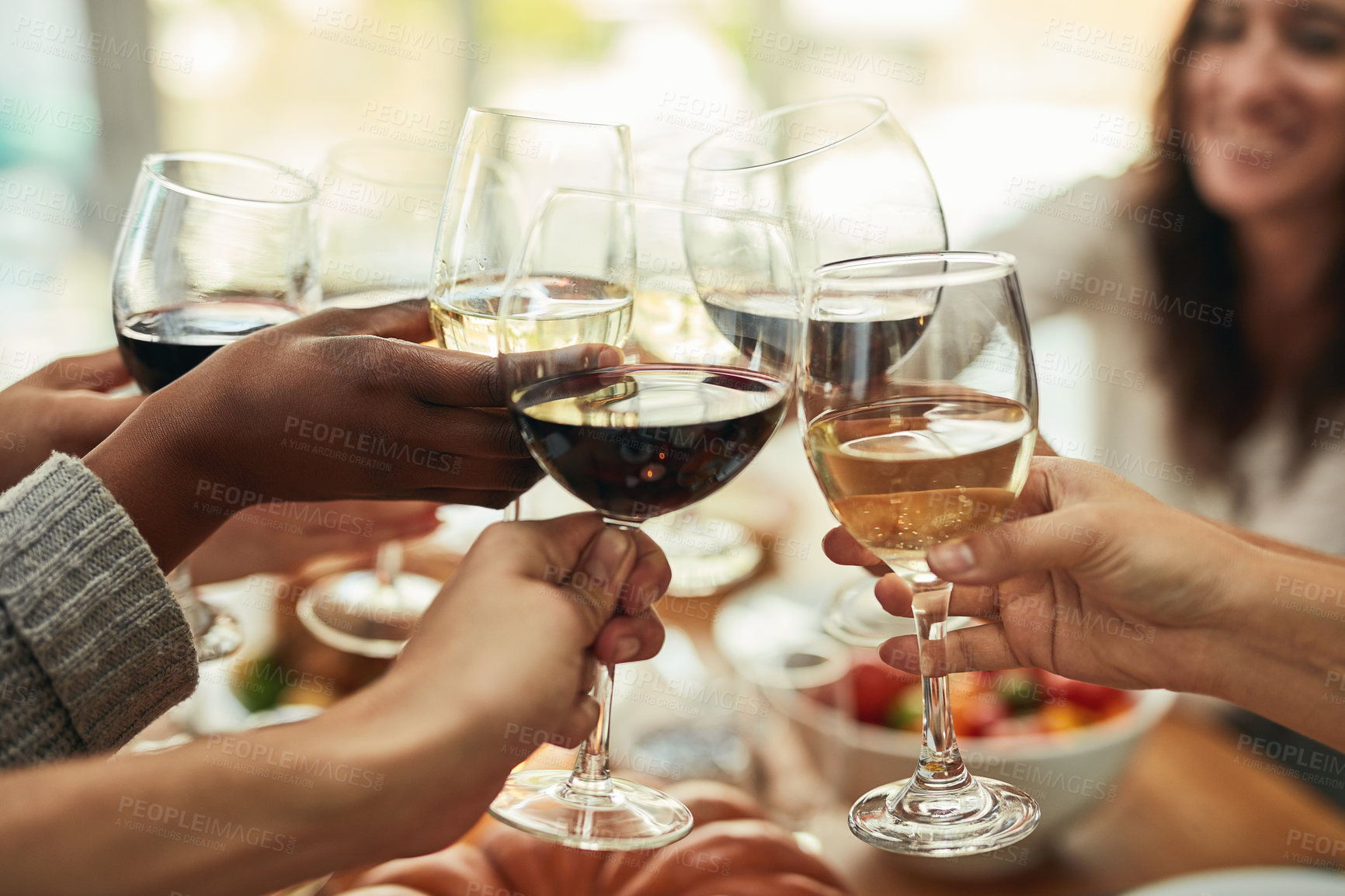 Buy stock photo Cropped shot of a group of people making a toast at a dining table