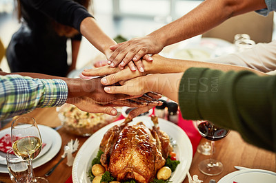 Buy stock photo Shot of a group of people stacking their hands at a dining table