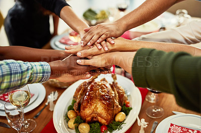 Buy stock photo Shot of a group of people stacking their hands at a dining table