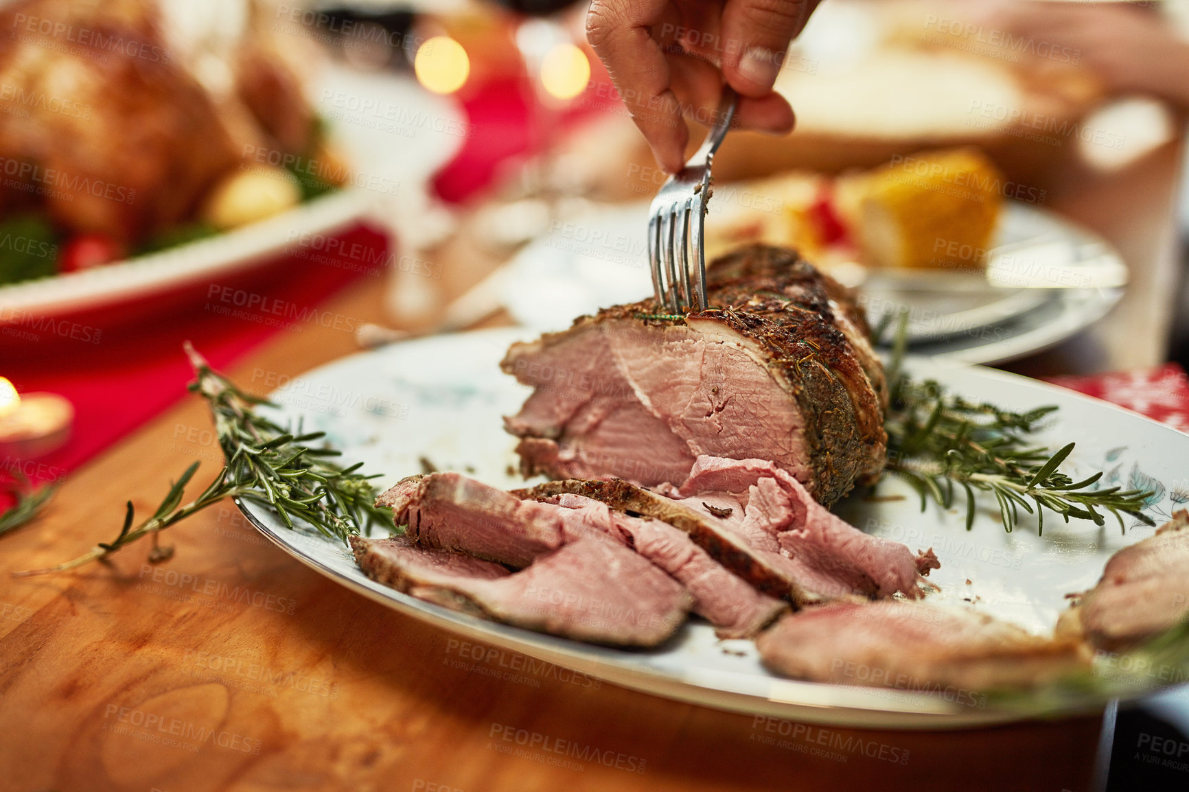 Buy stock photo Hand, fork and beef on a thanksgiving table for tradition or celebration in the holidays closeup from above. Food, meat and Christmas with a place setting on a wooden surface for healthy eating