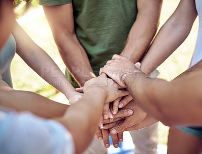 Buy stock photo High angle shot of a young group of friends standing outside with their hands in a huddle