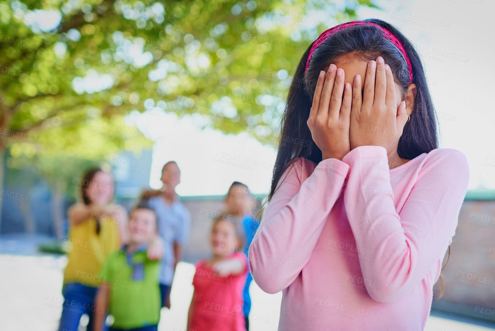 Buy stock photo Little girl, shame and bully with group at school for verbal abuse, pointing fingers and embarrased. Young victim, sad student or lonely child or kid mocked with hands covering face in cruel society