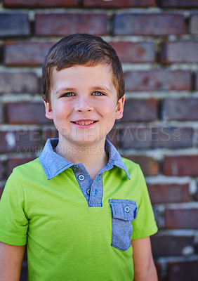 Buy stock photo Brick wall, school and portrait of child with smile for education, learning and development. Happy, student and face of little boy outside academy for scholarship, knowledge and growth in Germany