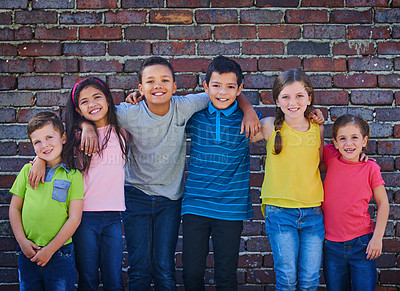 Buy stock photo Shot of a diverse group of children holding each other outside