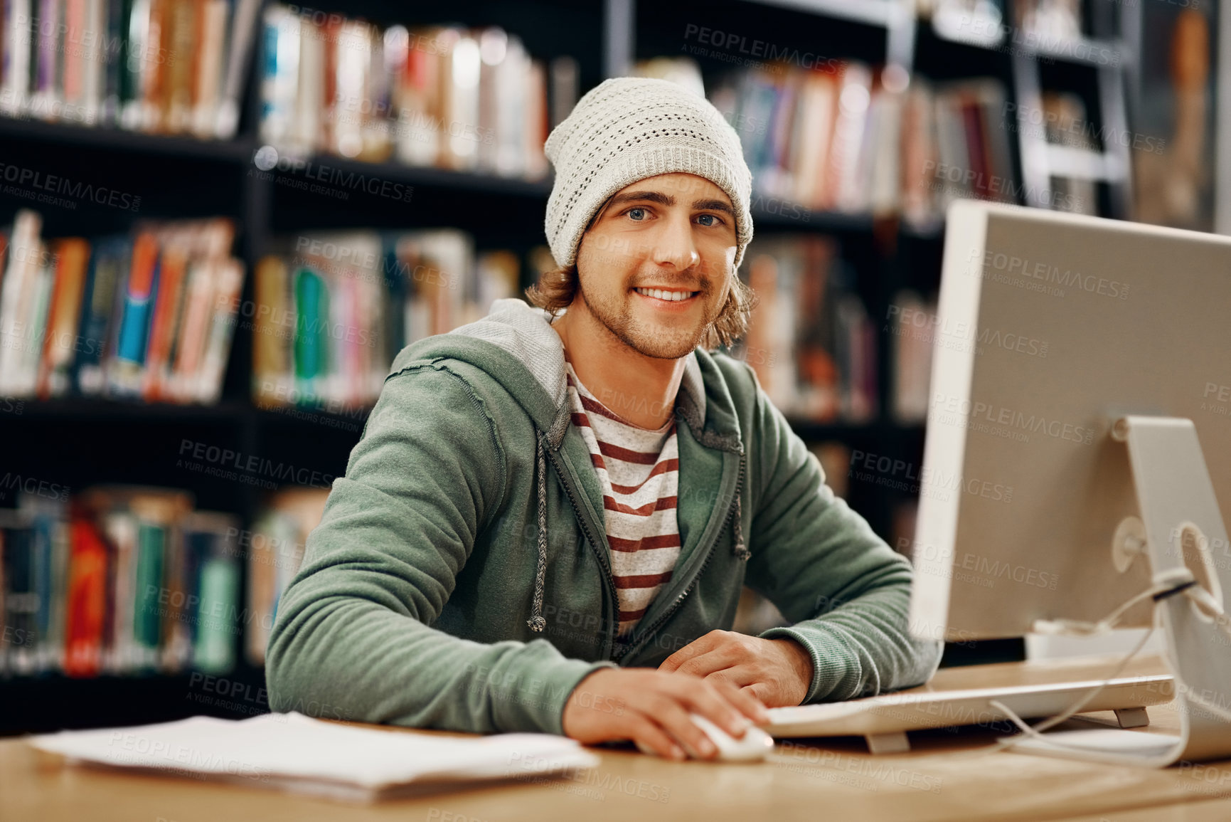 Buy stock photo Cropped portrait of a young male university student studying in the library