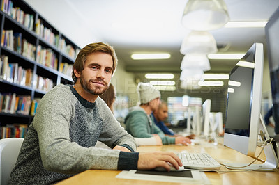 Buy stock photo Cropped portrait of a young male university student studying in the library