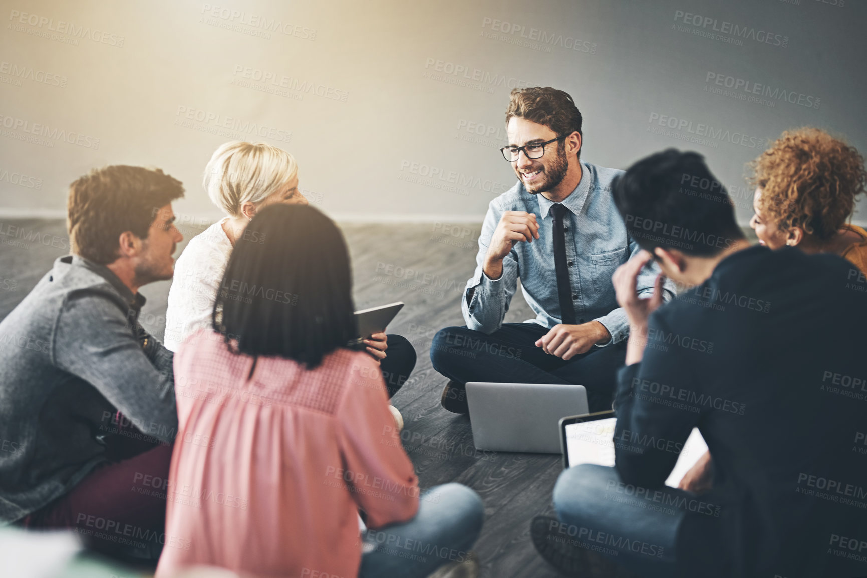 Buy stock photo Shot of a diverse group of creative employees having a meeting inside