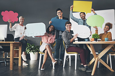 Buy stock photo Shot of a diverse group of creative employees holding up speech bubbles inside