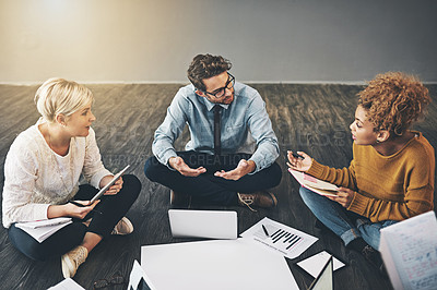 Buy stock photo Shot of a diverse group of creative employees having a meeting inside