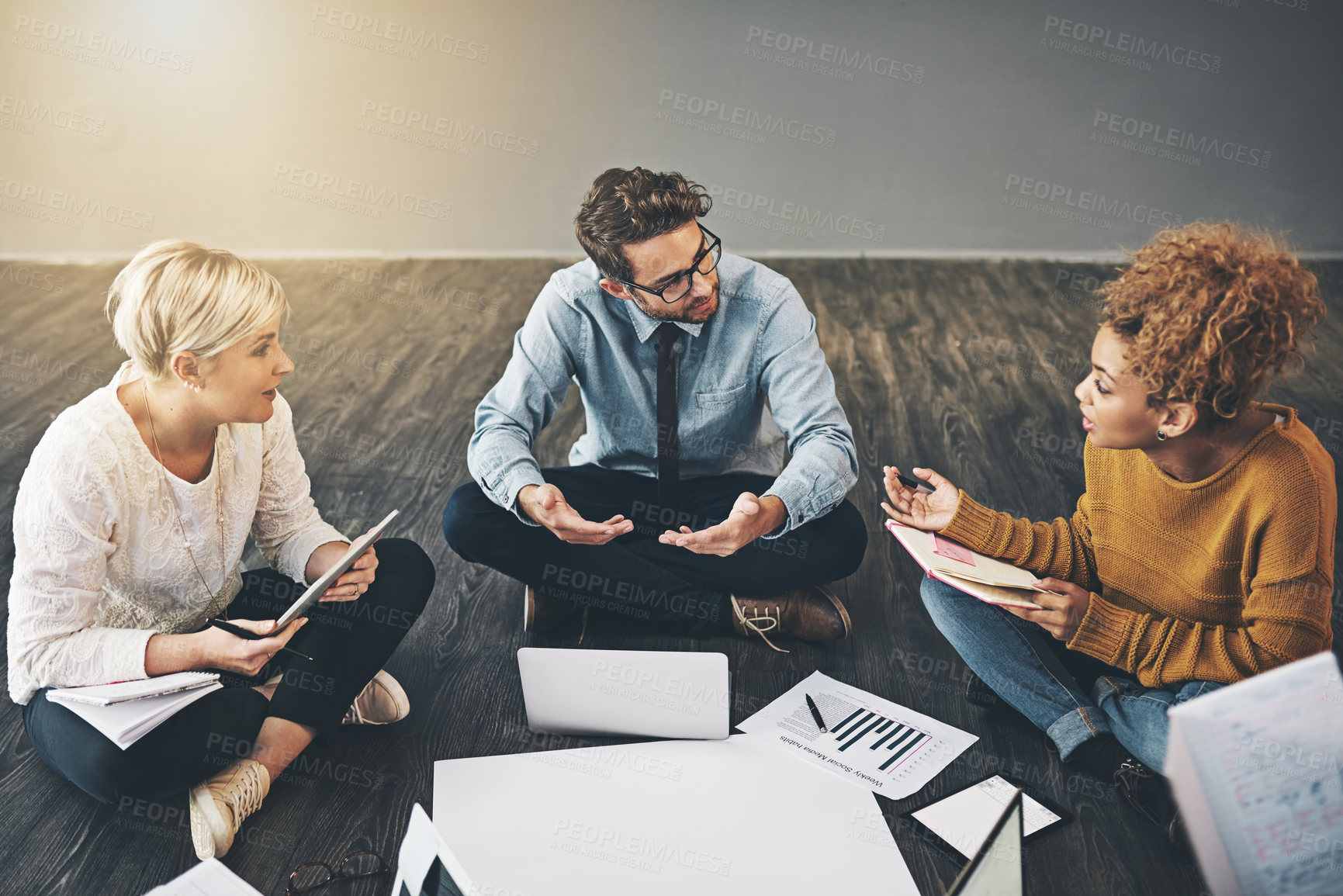 Buy stock photo Shot of a diverse group of creative employees having a meeting inside