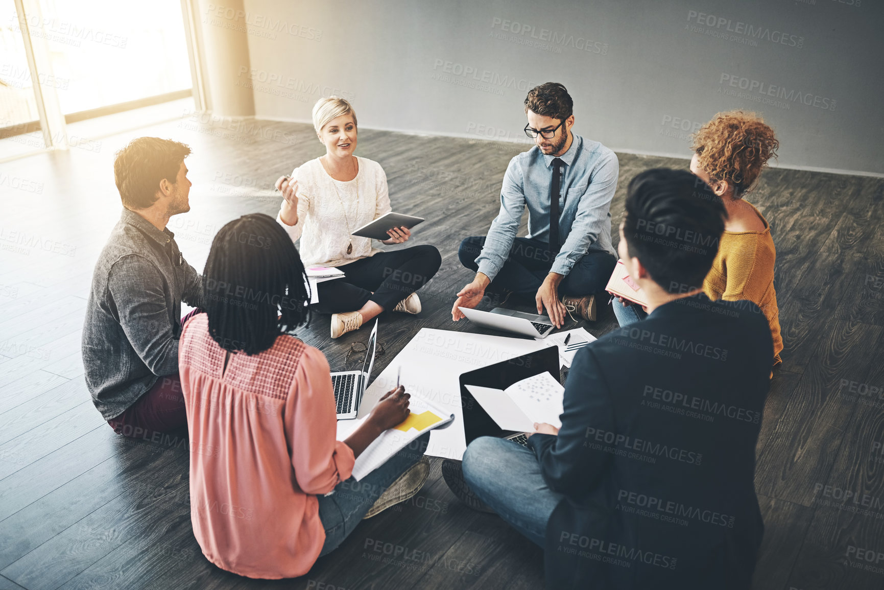 Buy stock photo Shot of a diverse group of creative employees having a meeting inside