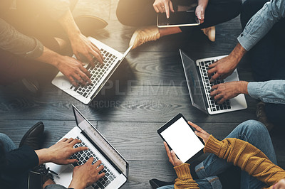 Buy stock photo Above group of colleagues working together on a project or business meeting using wireless technology. Top view of a diverse team brainstorming in a meeting. Team planning social media strategy 