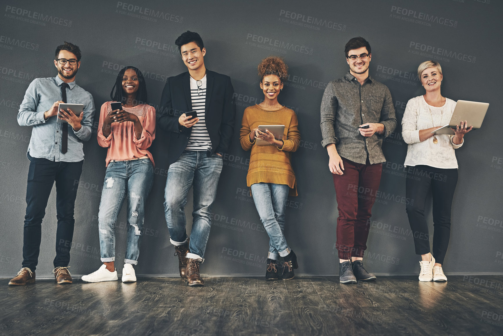 Buy stock photo Studio shot of a diverse group of creative employees social networking inside
