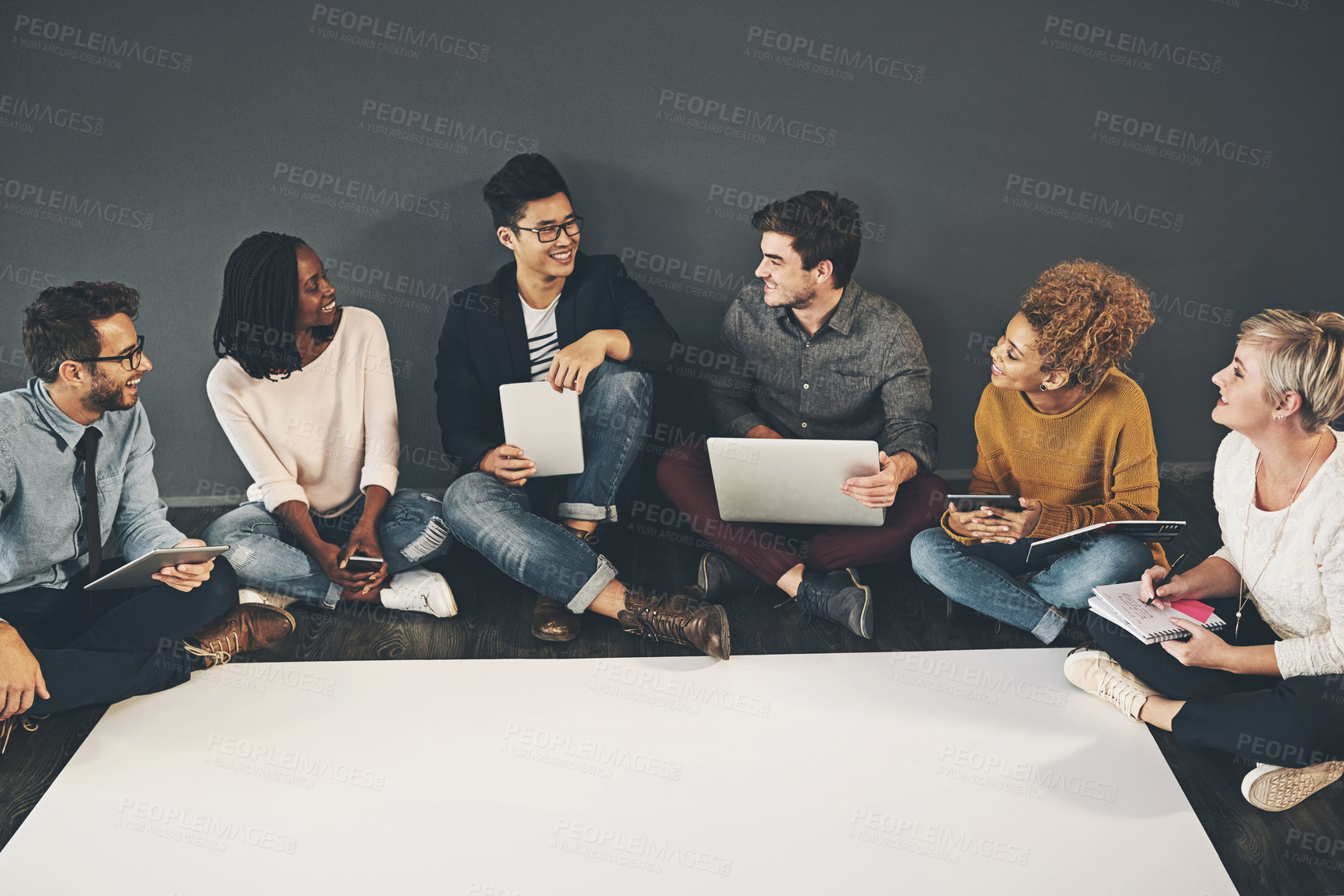 Buy stock photo Studio shot of a diverse group of creative employees having a meeting inside