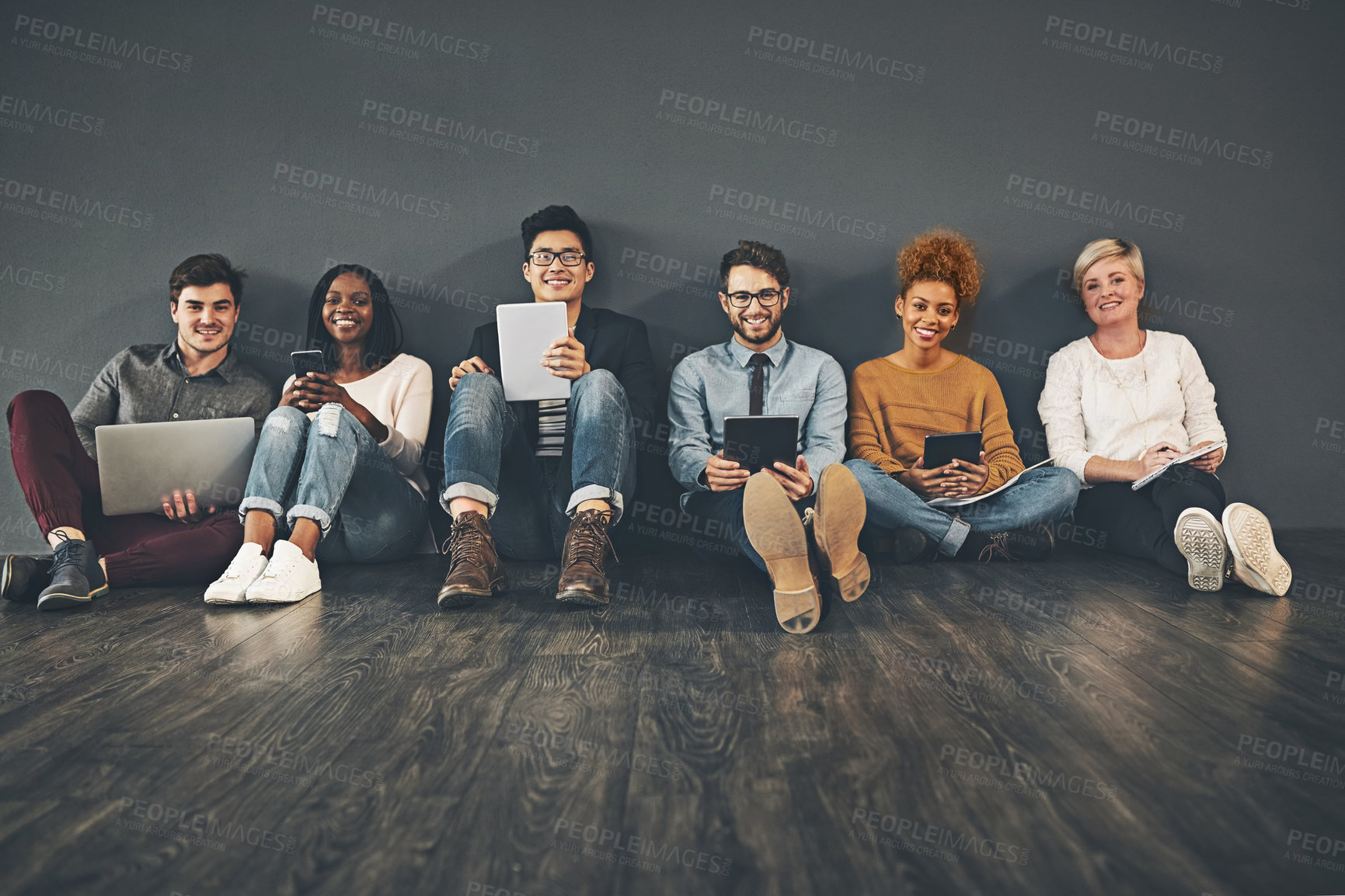 Buy stock photo Studio shot of a diverse group of creative employees social networking against a grey background
