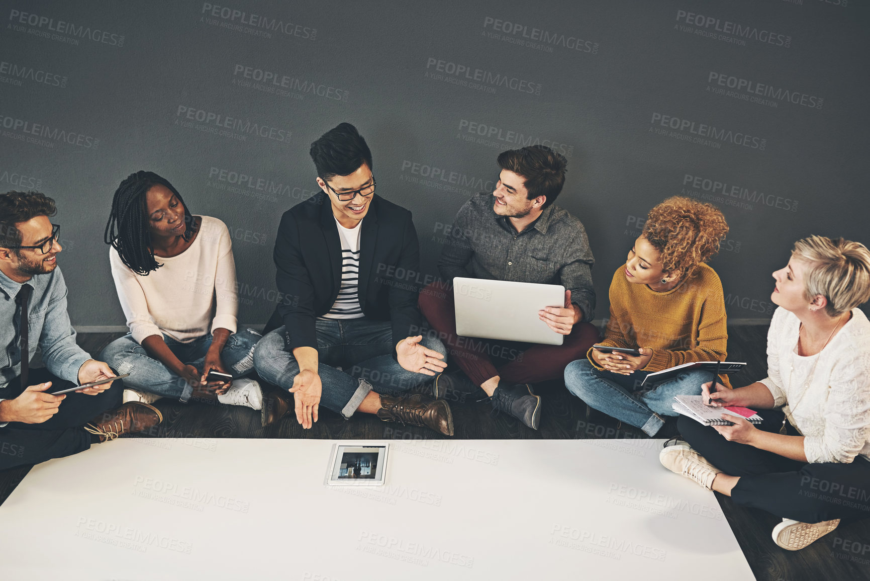 Buy stock photo Studio shot of a diverse group of creative employees having a meeting inside