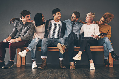 Buy stock photo Studio shot of a diverse group of creative employees embracing each other against a grey background