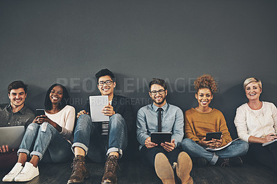 Buy stock photo Studio shot of a diverse group of creative employees social networking against a grey background