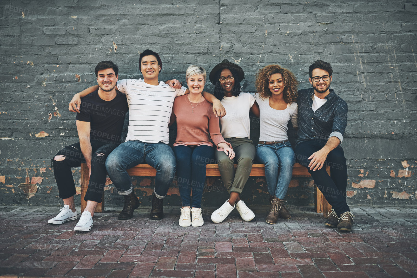 Buy stock photo Shot of a diverse group of people chilling together outside