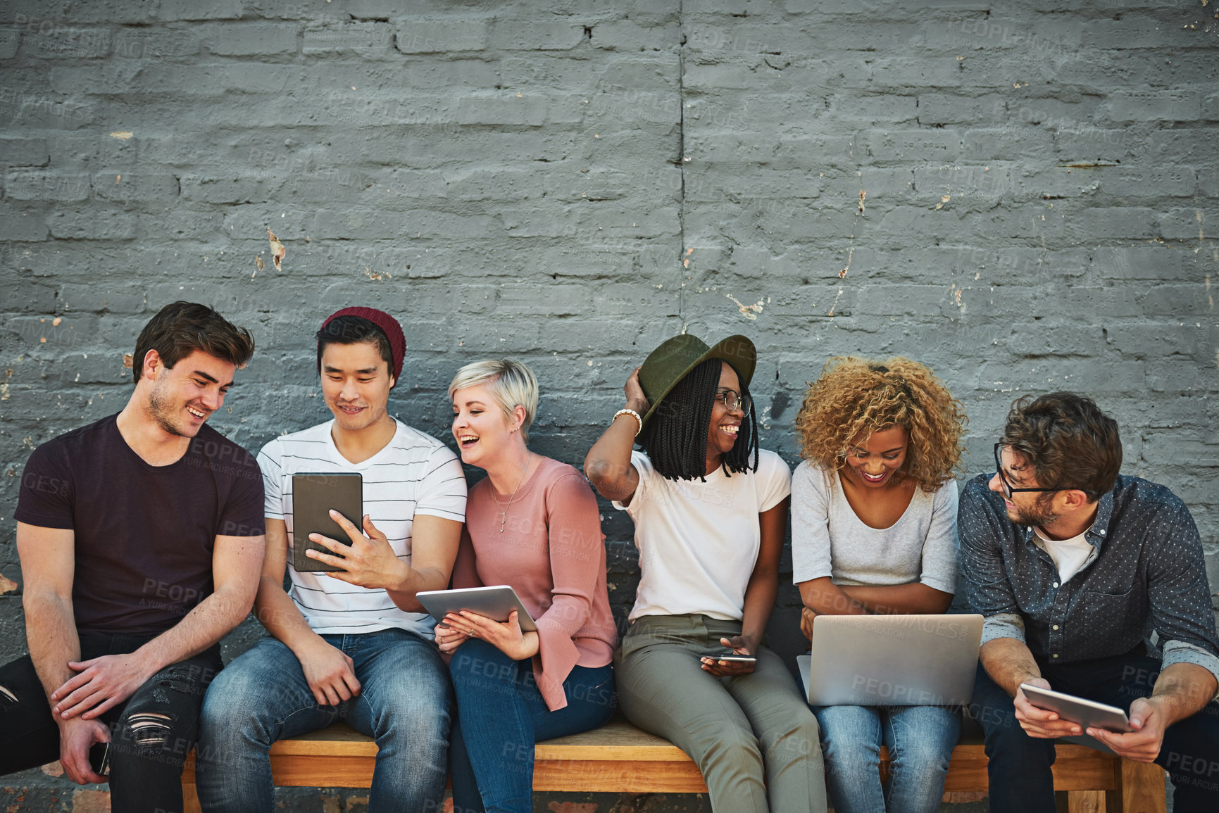 Buy stock photo Shot of a diverse group of people social networking outside