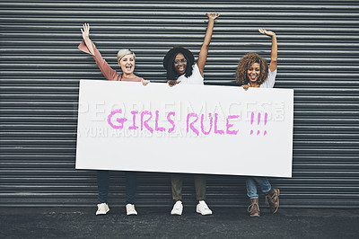 Buy stock photo Shot of a group of diverse females holding up a placard outside