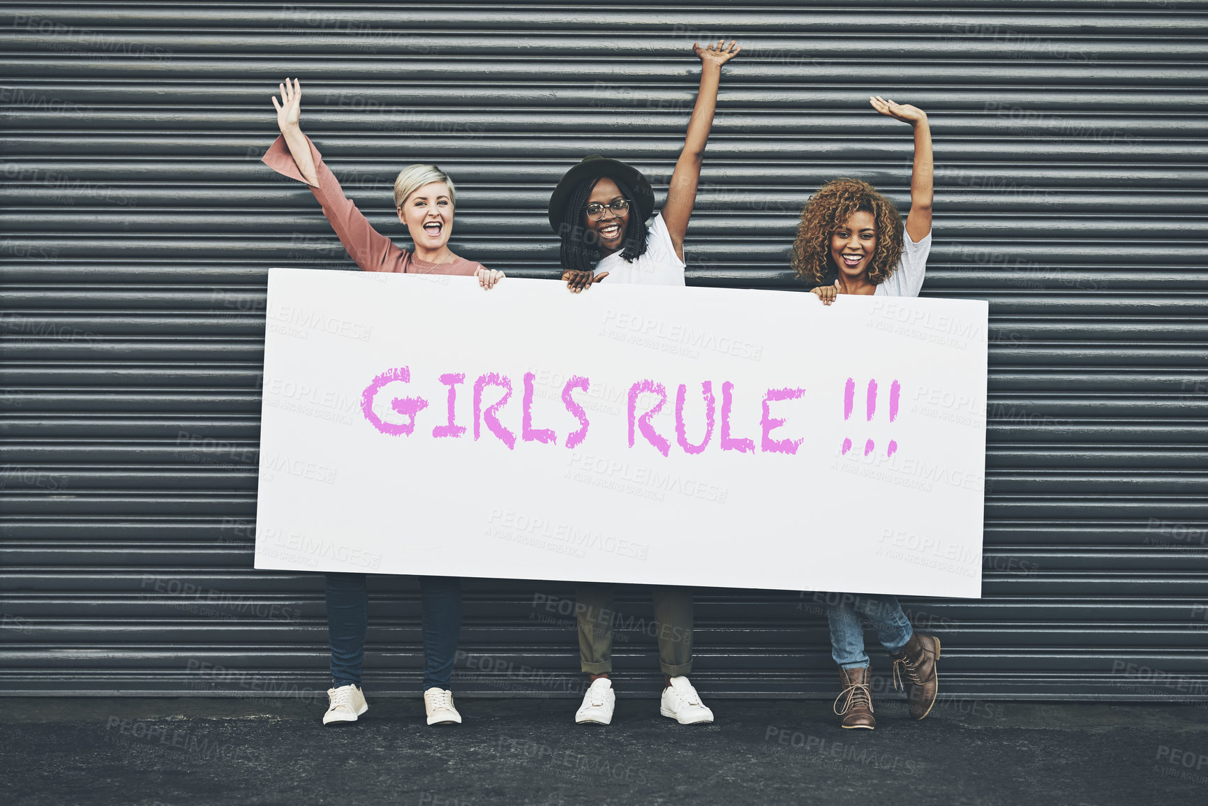 Buy stock photo Shot of a group of diverse females holding up a placard outside