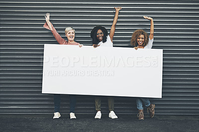 Buy stock photo Shot of a group of diverse females holding up a placard outside