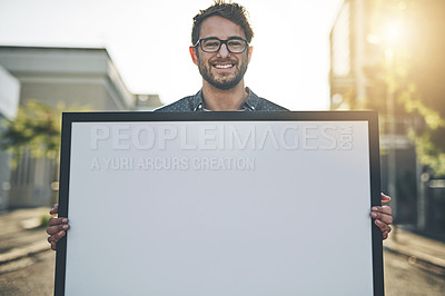 Buy stock photo Copyspace, marketing and advertising with a young business man holding a blank sign or poster. Portrait of a creative male showing ad copy space to promote a startup, service or design company