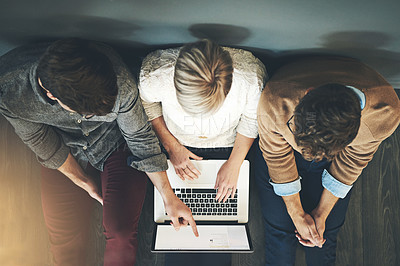 Buy stock photo A group of planning, researching and professional business people working together on a laptop while sitting on the floor top view. A team of designers searching the web or completing a project