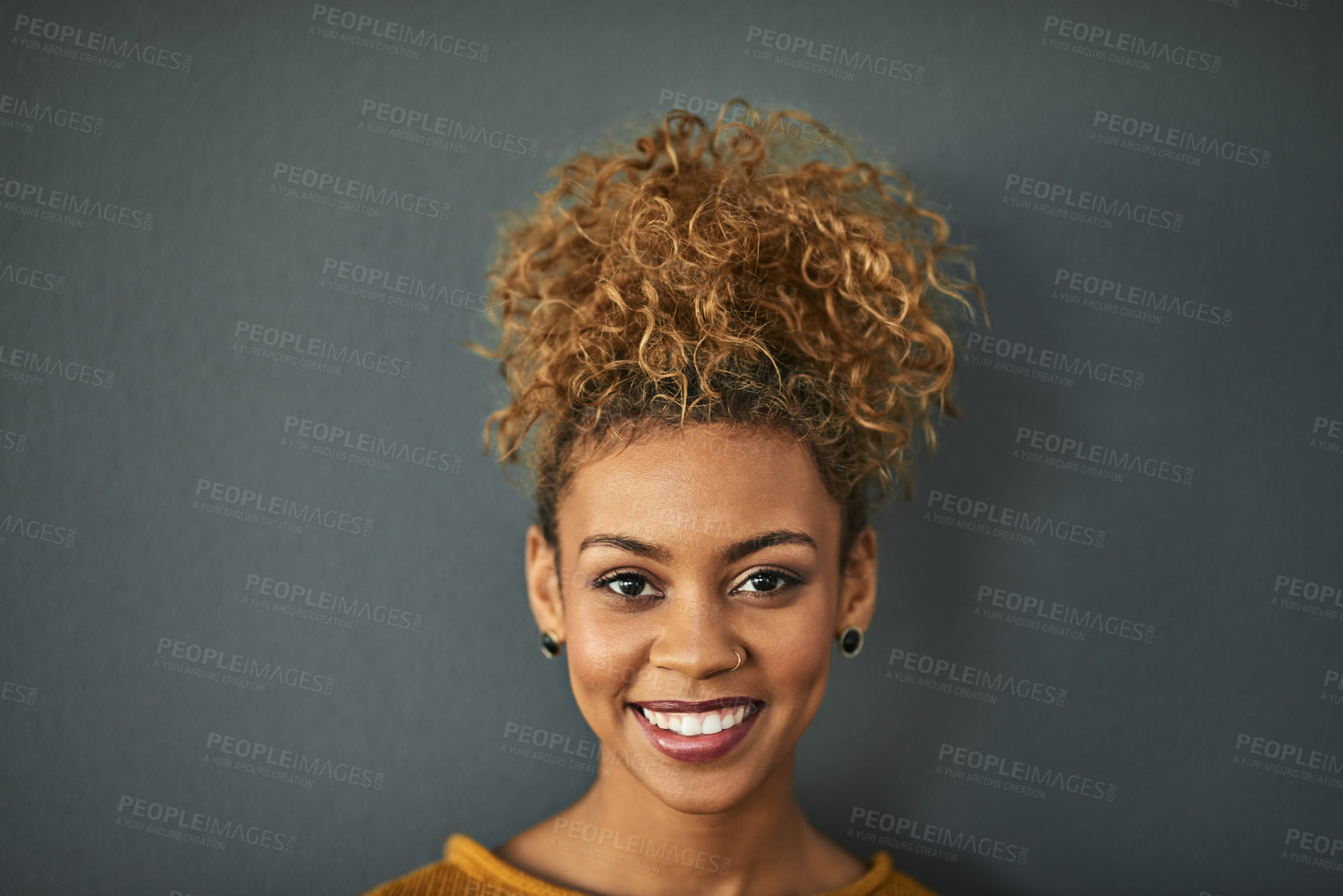 Buy stock photo Happy woman, portrait and natural beauty in studio, curls and cosmetics on gray background. Female person, smile and makeup treatment on mockup space, dermatology satisfaction and confident skincare