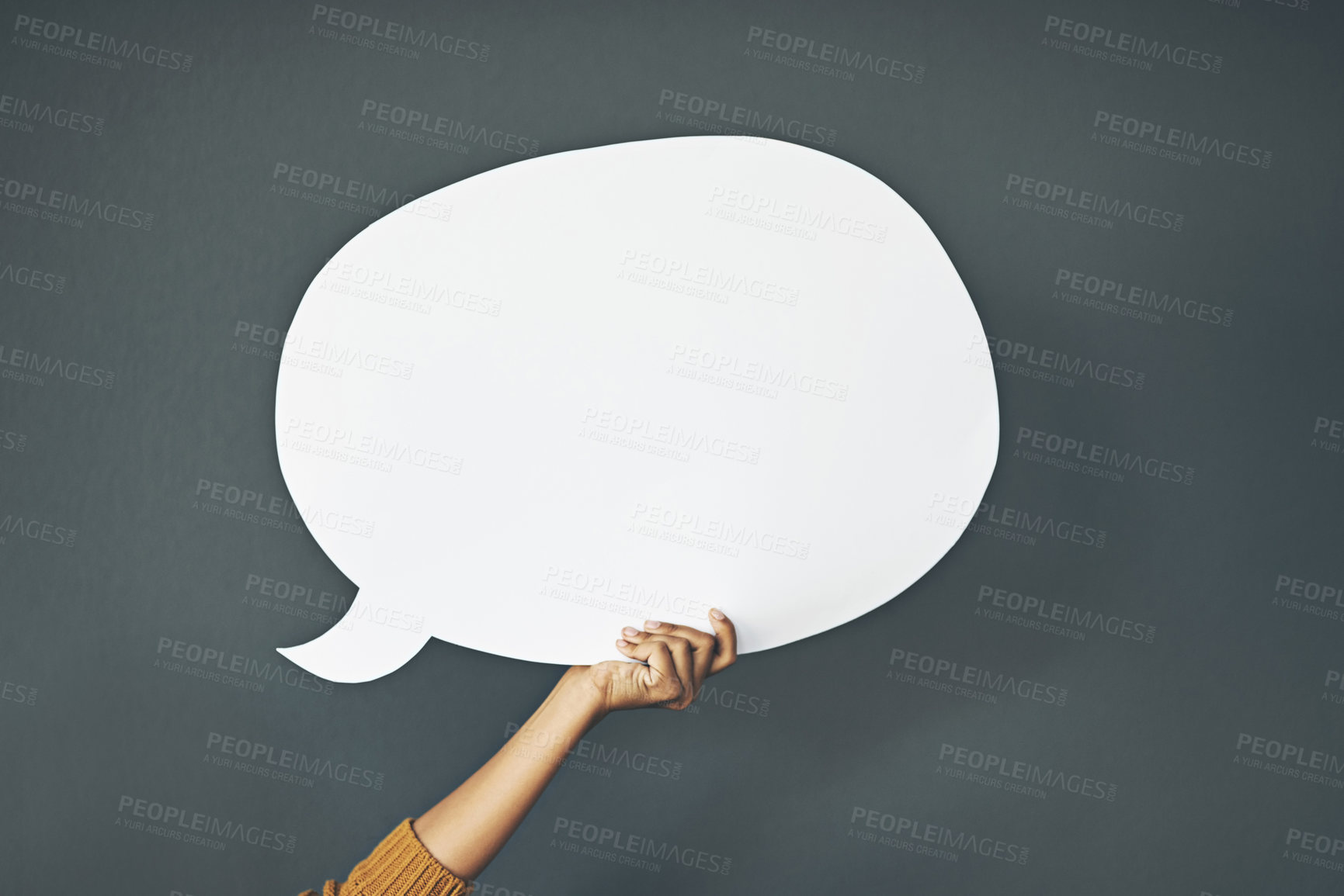 Buy stock photo Studio shot of an unrecognisable woman holding a speech bubble against a grey background