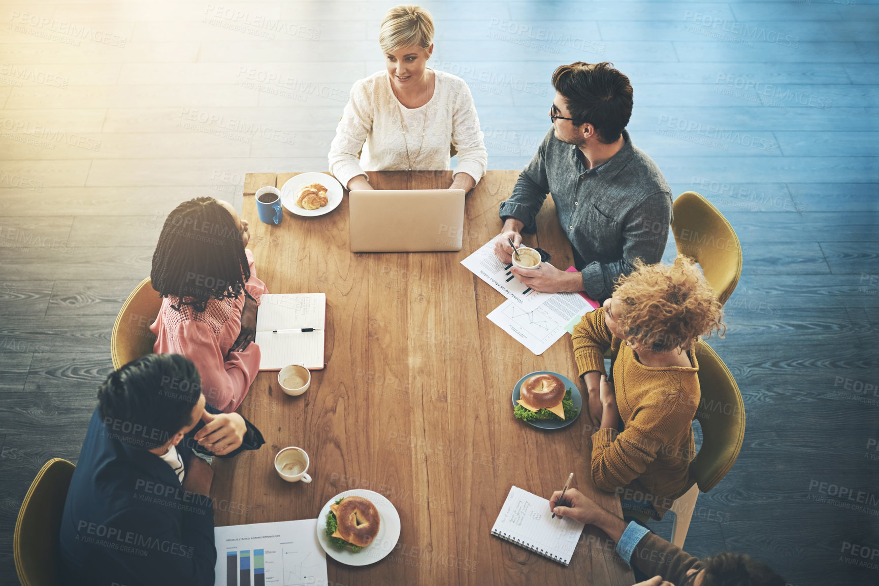 Buy stock photo Office, meeting and above of business people in discussion, project feedback and planning. Creative agency, laptop and men and women with documents for teamwork, collaboration and brainstorming