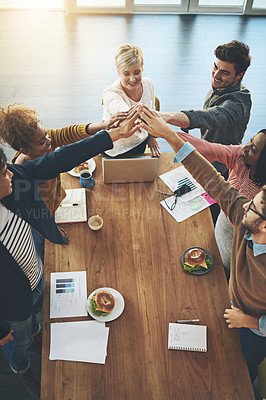 Buy stock photo Shot of a group of businesspeople joining their hands together in unity in an office