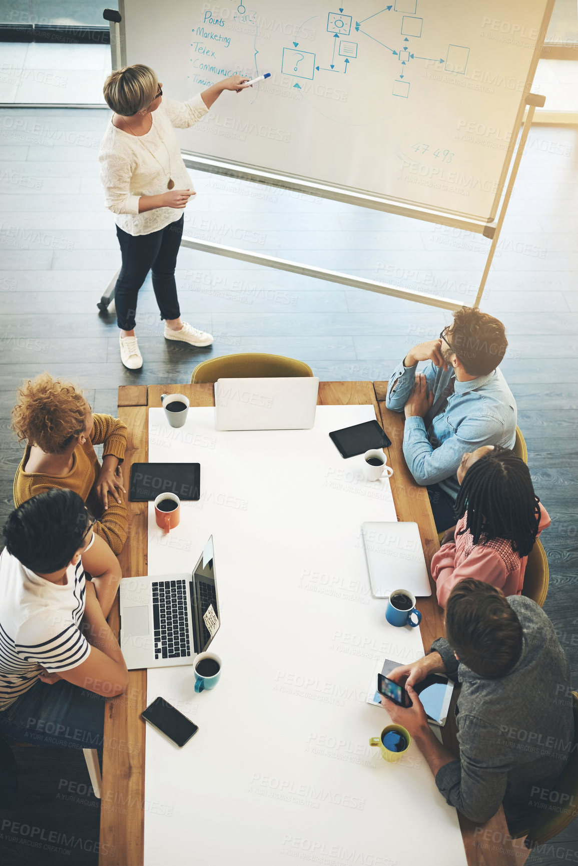 Buy stock photo High angle shot of a businesswoman giving a presentation to her colleagues in an office