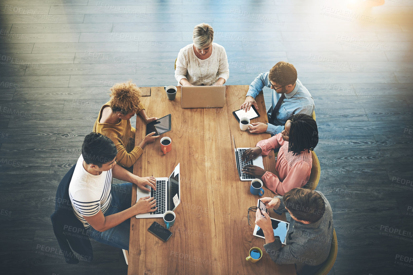 Buy stock photo High angle shot of a group of businesspeople having a meeting in an office