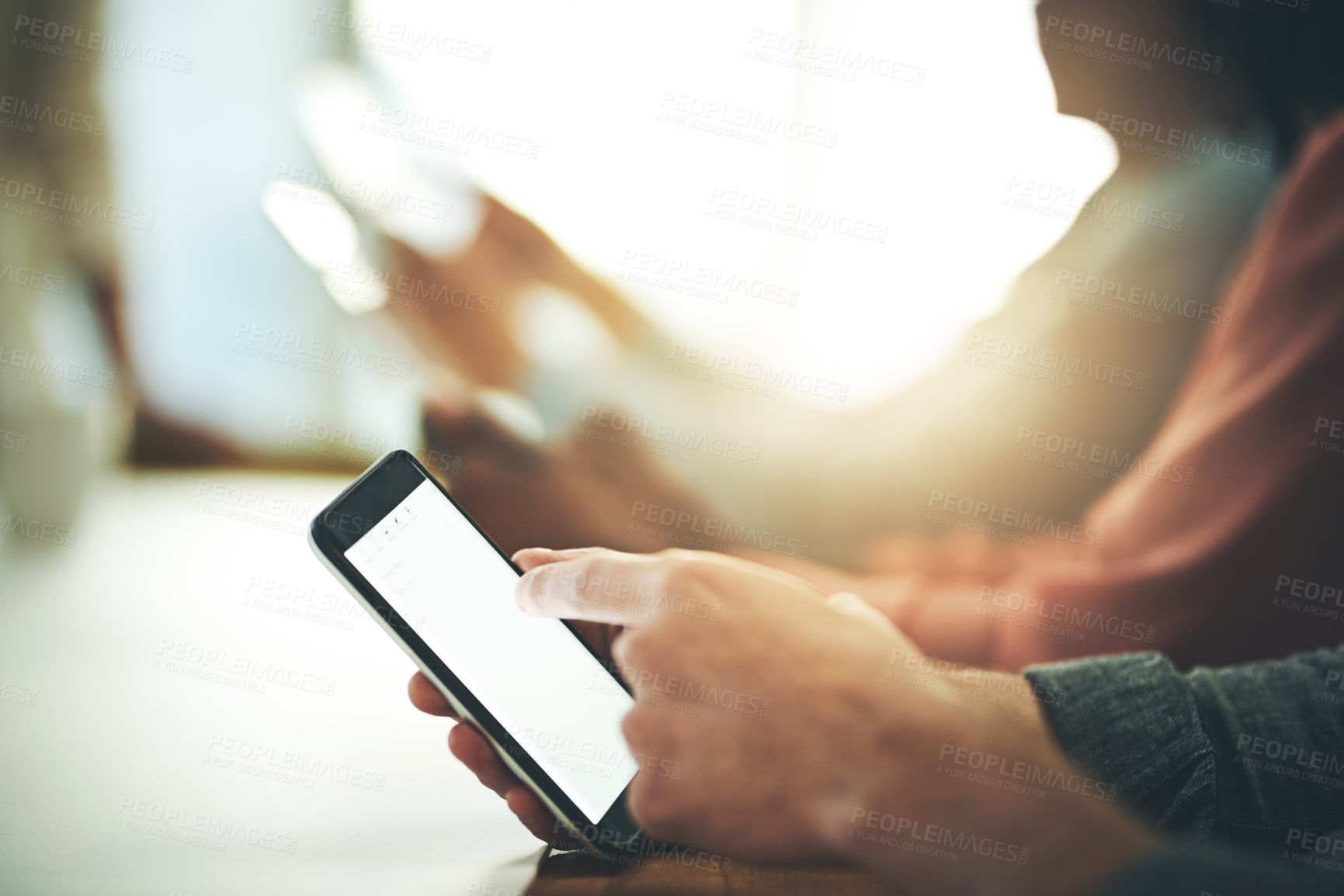 Buy stock photo Shot of an unrecognisable businessperson using a cellphone in an office