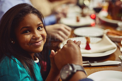 Buy stock photo Portrait, meal and girl with her family, prayer and happiness with joy, home or religious. Face, young person or female child holding hands, praying and worship for blessing, food or social gathering