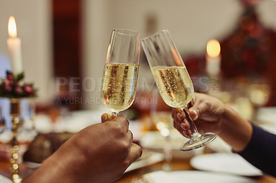 Buy stock photo Closeup shot of two people making a toast at a dining table
