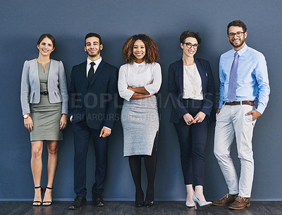 Buy stock photo Studio shot of a group of businesspeople standing in line against a gray background