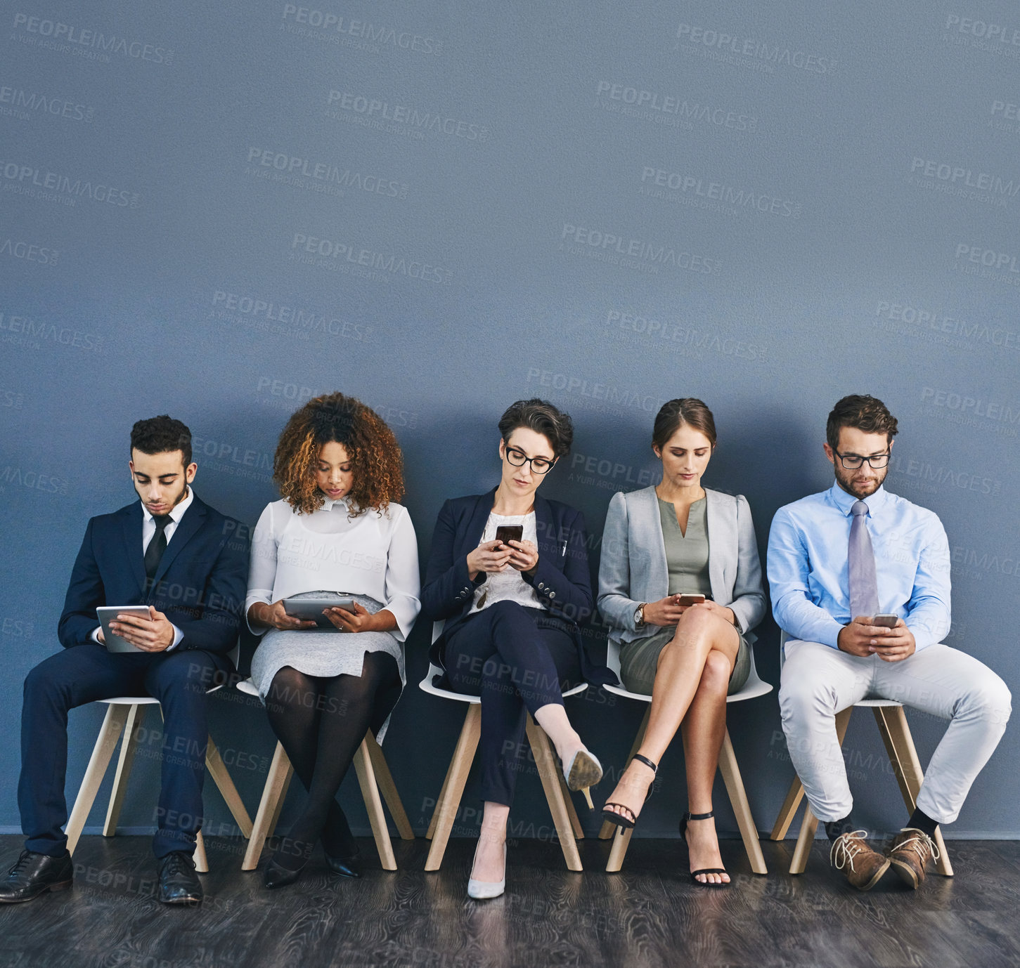 Buy stock photo Group of business people at a job interview at a small startup company with copy space. Businesspeople sitting and waiting in line for a meeting with human resources and applying for work