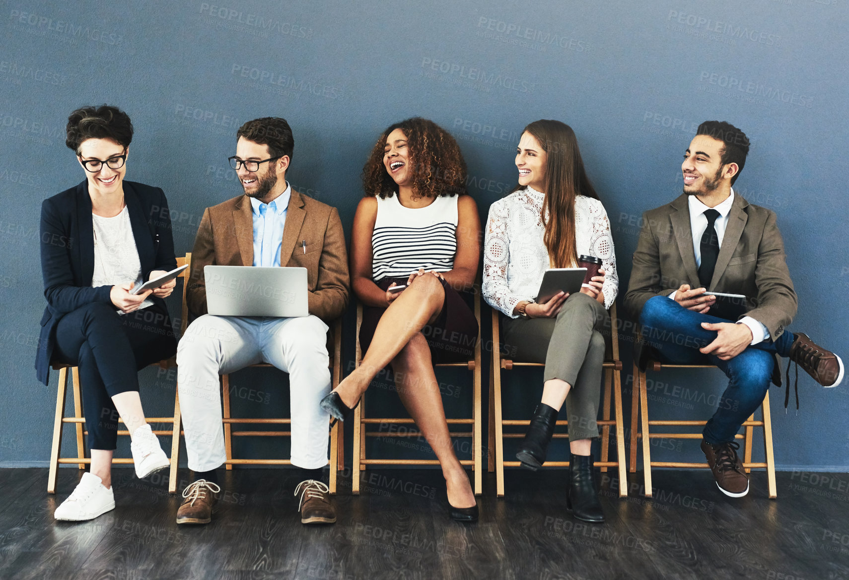 Buy stock photo Talking, technology and business people in waiting room for interview, meeting or recruitment on chair. Hiring, HR and diversity candidates in office for opportunity, onboarding or employment