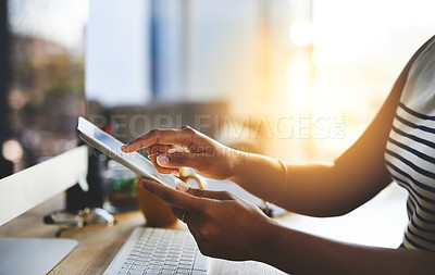 Buy stock photo Cropped shot of an unrecognizable businesswoman working on a digital tablet