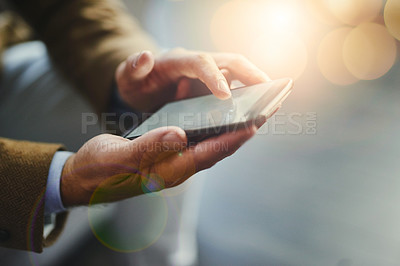 Buy stock photo High angle shot of an unrecognizable businessman using a mobile phone